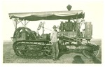 Man next to Holt 75 Caterpillar tractor by unidentified