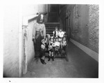 Amateur Theatricals - Stockton: A young man with a group of children dressed as pirates at the foot of stairs by Van Covert Martin