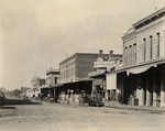 Stockton - Streets - 1850s - 1870s: El Dorado St. looking north from Market St., Stockton Theatre and W. A. Dorr and Schuttler Farm and Spring Wagons by Unknown