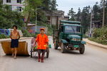 People and green truck in Liping by Marie Anna Lee