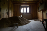 Room with pile of rice stored in it by Marie Anna Lee