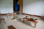 Wu Yingniang in room with lunch for all helpers on traditional low half tables