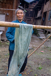 Taking cloth out and hanging on pole to dry by Marie Anna Lee