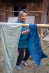 Displaying dyed indigo cloth by Marie Anna Lee