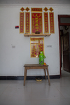 Altar at Wu Gaitian’s home with water and toys by Marie Anna Lee