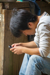 Young boy looking at touchscreen phone