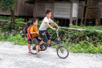 Children on bike by Marie Anna Lee
