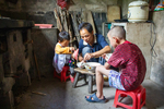 Wu Gaitian's son feeds children by Marie Anna Lee