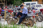 Policeman on motorbike with phone