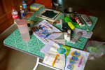 Interior of the building, items on table, grandson works on summer homework