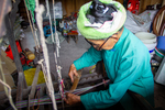 Wu Gaitian working on the frame loom weaving by Marie Anna Lee