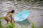 Girl with umbrella in river