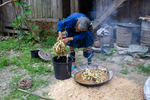 Wu Meitz putting mulberry bark in wok by Marie Anna Lee