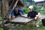 Wu Meitz teaching how to use papermaking mould
