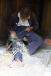 Man whittling rattan