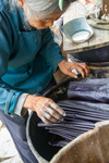 Wu Meitz dyes fabric in indigo vat