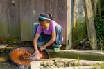 Girl washing shallow woven scuttle