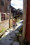 Woman walking through an alley by Marie Anna Lee
