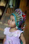 Baby wearing a festive baby hat by Marie Anna Lee