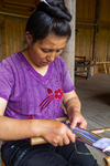 Wu Liangming weaving a flower belt on backstrap loom by Marie Anna Lee