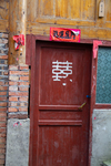 Red door with Chinese character by Marie Anna Lee
