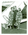 Football-University of the Pacific mascot with two flight attendants in front of plane by unknown