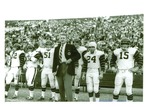 Football-University of the Pacific football players and coach on sidelines during Homecoming game by unknown