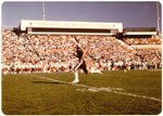 Buildings-Football player running during game at Stagg Stadium by unknown