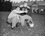 Football-University of the Pacific football coach and player on field. by unknown