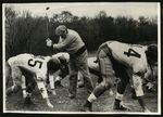 Football-unidentified players with golfer by unknown