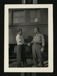 Football-University of the Pacific coach shaking hands with another man in front of train car during trip to Chicago by W.F. Hodges Photos