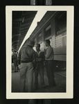 Football-Three men next to train car during trip to Chicago by W.F. Hodges Photos