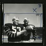 Football-Two unidentfied University of the Pacific players holding ball by unknown