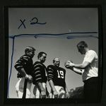 Football-Three unidentified players with coach Doug Scovil by unknown