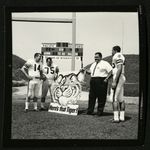 Football-University of the Pacific coach Don Campora and players next to promotional Tigers sign by unknown
