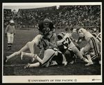 Football-University of the Pacific players on field during game by Miller Photography