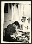 Student Surrounded by Memoribilia by Elbert Covell College