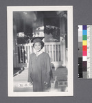Girl in graduation costume [in front of building; 38-8-D] by Richard Shizuo Yoshikawa