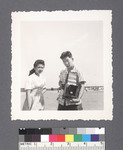 Man (with camera) & woman: Fred Yamaguchi (R) by Richard Shizuo Yoshikawa
