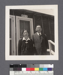 Man & woman in front of building: Misaho and Nisuke Yoshikawa