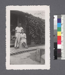 Man & woman seated on porch #2