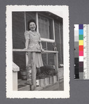 One woman #39 [standing on porch, holding railing] by Richard Shizuo Yoshikawa