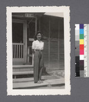 One woman #78 [standing on porch]