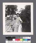 One woman #80 [standing on bridge, pointing]