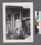 One woman #81 [standing on porch; building 40-12-C] by Richard Shizuo Yoshikawa