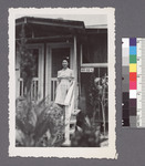 One woman #82 [standing on porch; building 40-12-C] by Richard Shizuo Yoshikawa