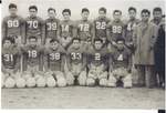 Football: Bronce Football Team 1943 in uniforn in 2 rows #2: Top row L-R Tom Kitagawa (90), James Tsutsui (70), Junji Sasaki (39), Eugene Sakasagawa (14), Charles Yamada (72), Yoshio Fujii (22), Joe Matsuo (99), Shozo Watanabe (44), George Shigehira-Manager, Eddie Wakimoto-coach, Fred Masai-coach. Bottom row L-R Shigeo Hayashi (31), Ray Kurihara (19), Norman Shimakawa (38), Hank Okura (33), Yutaka Matsumoto (2), Herby? (4) by Richard Shizuo Yoshikawa
